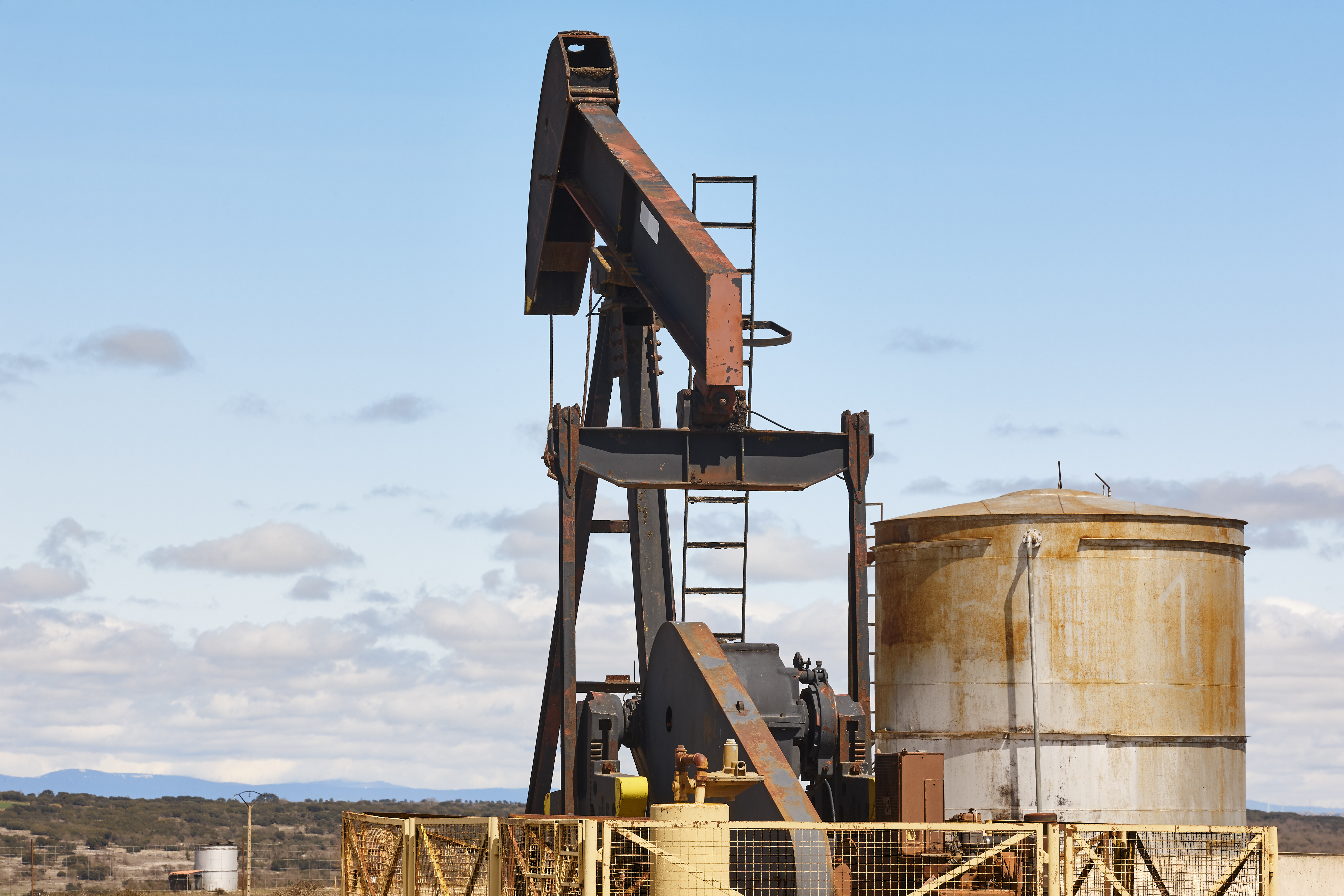 A pump jack extracting crude oil at a petroleum facility